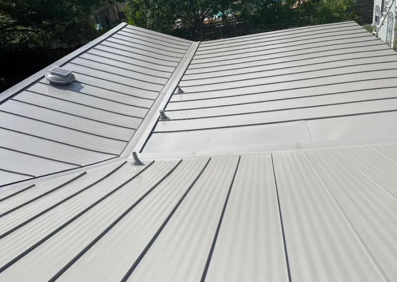 Solar attic fan installed on a metal roof for Roof Ventilation in Athol